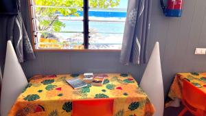 a table in a room with a view of the ocean at Hiti Tikehau, the ocean side bungalow in Tikehau