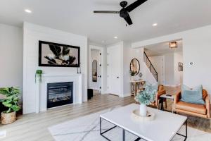 a living room with a table and a fireplace at Midway to Heaven! BRAND NEW 5 bed 4.5 bath, HOTTUB in Midway