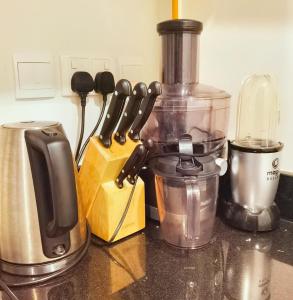 a kitchen counter with a food processor and a blender at Luxurious studio fully furnished 5 stars hotel facilities in Dubai South in Dubai