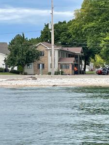 a house on the shore of a body of water at Lake Point Motel in Marblehead