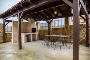 a dining room with a table and chairs and a fireplace at Casa Triskel in Valdeavellano de Ucero