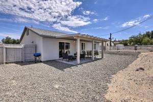 a white house with a fence and a patio at Pet-Friendly Bullhead City Abode with Game Room in Bullhead City