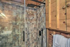 a bathroom with a shower with a stone wall at Deer Haven Cabin 5 Mi to Dtwn Blue Ridge! in Blue Ridge +22 photos