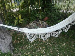 a hammock in a garden with rocks in it at Bamboo gardens in Nea Irakleia