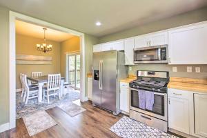 a kitchen with stainless steel appliances and a dining room at Historic Home Near Bathhouse Row in Hot Springs! in Hot Springs +16 photos