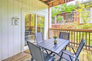 a porch with a table and chairs on a deck at Historic Home Near Bathhouse Row in Hot Springs! in Hot Springs
