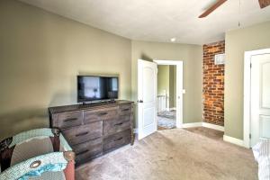 a living room with a television on a dresser at Historic Home Near Bathhouse Row in Hot Springs! in Hot Springs
