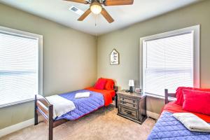a bedroom with two beds and a ceiling fan at Historic Home Near Bathhouse Row in Hot Springs! in Hot Springs
