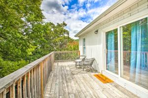 a wooden deck with a chair on a house at Historic Home Near Bathhouse Row in Hot Springs! in Hot Springs
