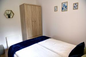 Łóżko lub łóżka w pokoju w obiekcie Apartament Tamaryszek