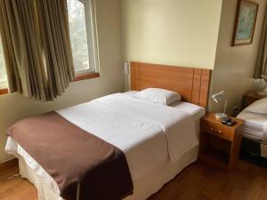 Cama ou camas em um quarto em Hotel Residencial Alfa