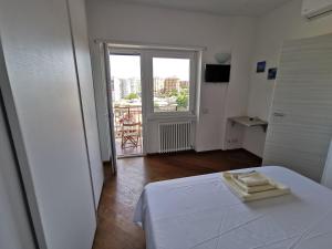Posteľ alebo postele v izbe v ubytovaní Locazione Turistica Marinella Roma
