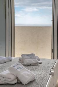 A bed or beds in a room at white house by the sea