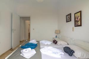 A bed or beds in a room at white house by the sea