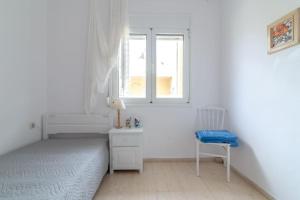 A bed or beds in a room at white house by the sea