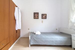 A bed or beds in a room at white house by the sea