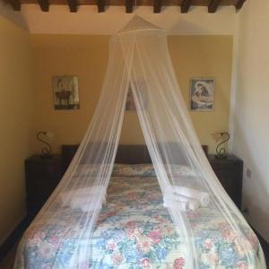 a bed with a canopy in a bedroom at La Rocca delle Pigne in Cana