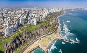 uma vista aérea de uma cidade e do oceano em Great Partners hostel em Lima
