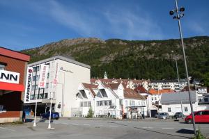 a town with buildings and a mountain in the background at Charming Bergen house, rare historic house from 1779, Whole house in Bergen