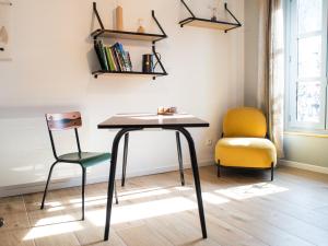 a table and two chairs in a room at Le Saunerie - Sleep in Sisteron in Sisteron