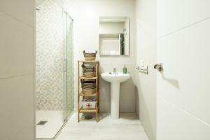 a bathroom with a sink and a shower at Apartamento Mucha Vida Little Apartments in Cádiz +22 photos