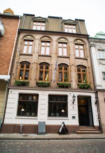 a large brick building with windows on a street at H5 Hotel in Helsingborg