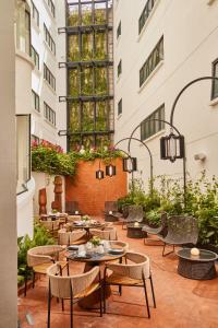 an outdoor patio with tables and chairs and plants at Campos Polanco in Mexico City