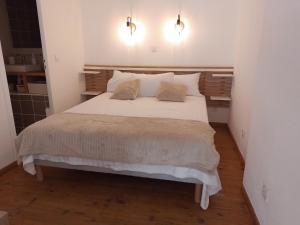 a bedroom with a large white bed with two pillows at Studio mezzanine hyper centre, au pied du castillet in Perpignan