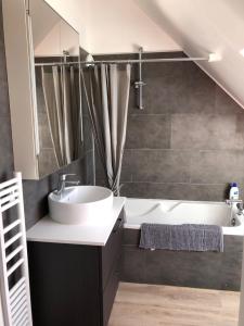 a bathroom with a sink and a bath tub at Appartement 3 Étoiles - Plage des Phoques avec Parking Privé in Berck-sur-Mer