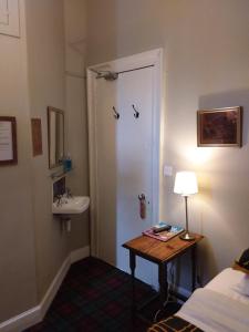 a room with a bathroom with a sink and a door at The City in Edinburgh