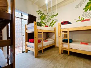 a room with three bunk beds in a room at Waikiki Hostel in Lima