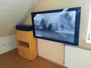 a large flat screen tv hanging on a wall at Ferienwohnung Albus in Albertshausen