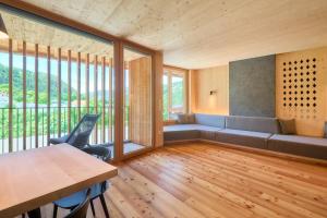 a living room with a couch and large windows at Kircherhof in Bressanone