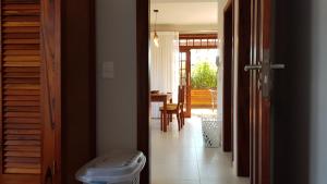 a hallway with a door open to a room at Flat - SERRA E MAR - Paraty in Paraty