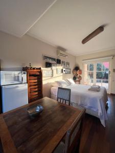 a bedroom with a bed and a table in front of it at Loft em Brotas in Brotas