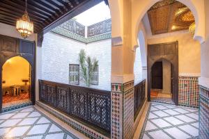 an indoor courtyard of a building with a chandelier at Riad Mazaj in Marrakesh