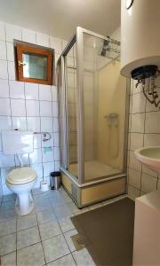 a bathroom with a shower and a toilet and a sink at Holiday house with a big garden and free parking 