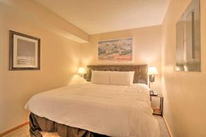 a bedroom with a large white bed with two lamps at Beaver Run Resort in Breckenridge