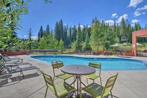 a swimming pool with chairs and a table next to a tablektop at Beaver Run Resort 4228 in Breckenridge