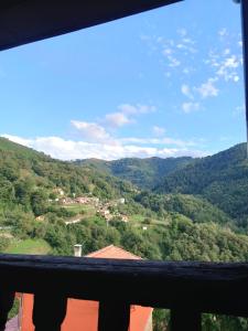 a view of a valley from the balcony of a house at El Carbayu - La Vallicuerra Casas Rurales in Mieres