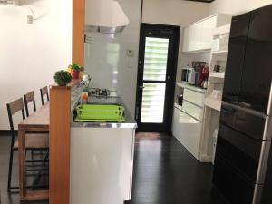 a kitchen with a table and a green tray on the counter at Fukugi no Yado - Vacation STAY 94994v in Amami