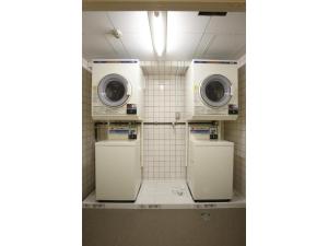 a laundry room with two washers and two machines at HOTEL RELIEF Namba Daikokuchou - Vacation STAY 33958v in Osaka