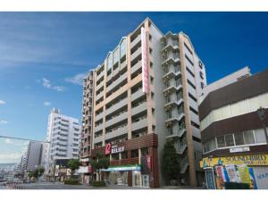 a tall building on a city street with buildings at HOTEL RELIEF Namba Daikokuchou - Vacation STAY 33958v in Osaka