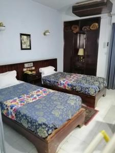 Postel nebo postele na pokoji v ubytování Windsor Hotel Luxor