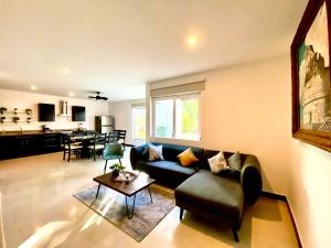 een woonkamer met een bank en een tafel bij VIA TENDENZA VILLAS in Playa del Carmen