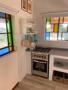 a kitchen with a stove and some stained glass windows at La Pelereca in Las Gaviotas +16 photos