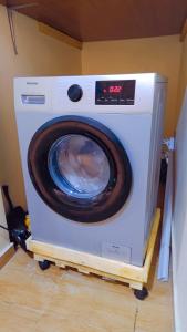 a washing machine with its door open in a room at Abuja Apartments 24 in Abuja