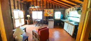 a room with a kitchen and a living room at Amanda's Place Casa Amancer - sea view, pool and tropical garden in Caye Caulker