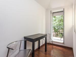 a black desk and chairs in a room with a window at Convento Apartment Rossio in Lisbon