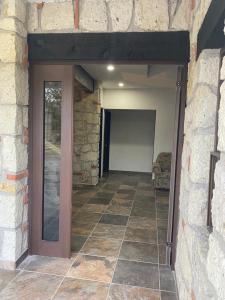 a door to a room with a stone wall at Hotel Villas La Mexicana in Tecozautla